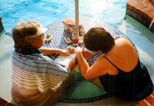 Karen gives Mommy a manicure in the pool.