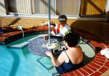 Karen & Mom play Rummy Cube in the pool.