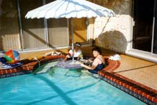 Karen & Mom play Rummy Cube in the pool.